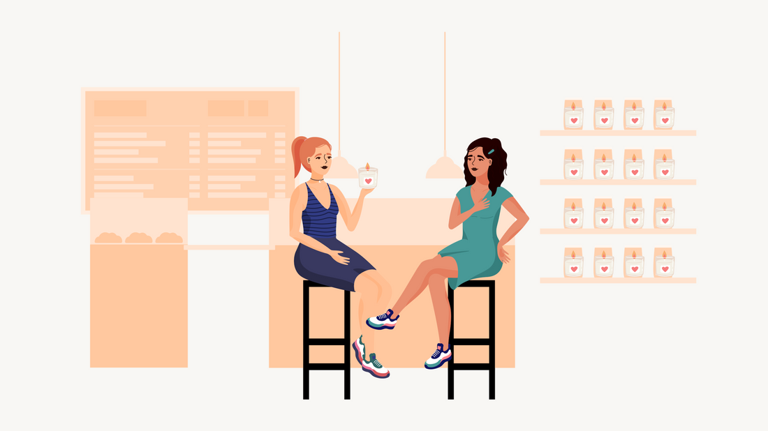 Two friends exchanging a candle gift at a cozy cafe.