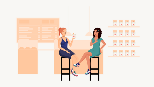 Two friends exchanging a candle gift at a cozy cafe.